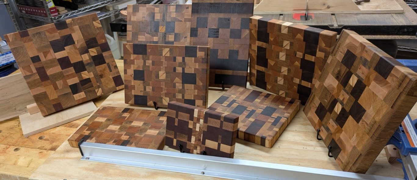 9 mosaic-design cutting boards that were made with scraps from my previous work.