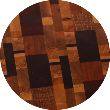 Close-up of mosaic design cutting board with many species of wood.